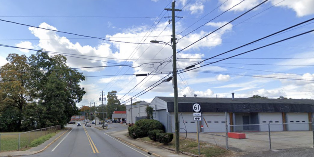 a street with power lines and cars on it